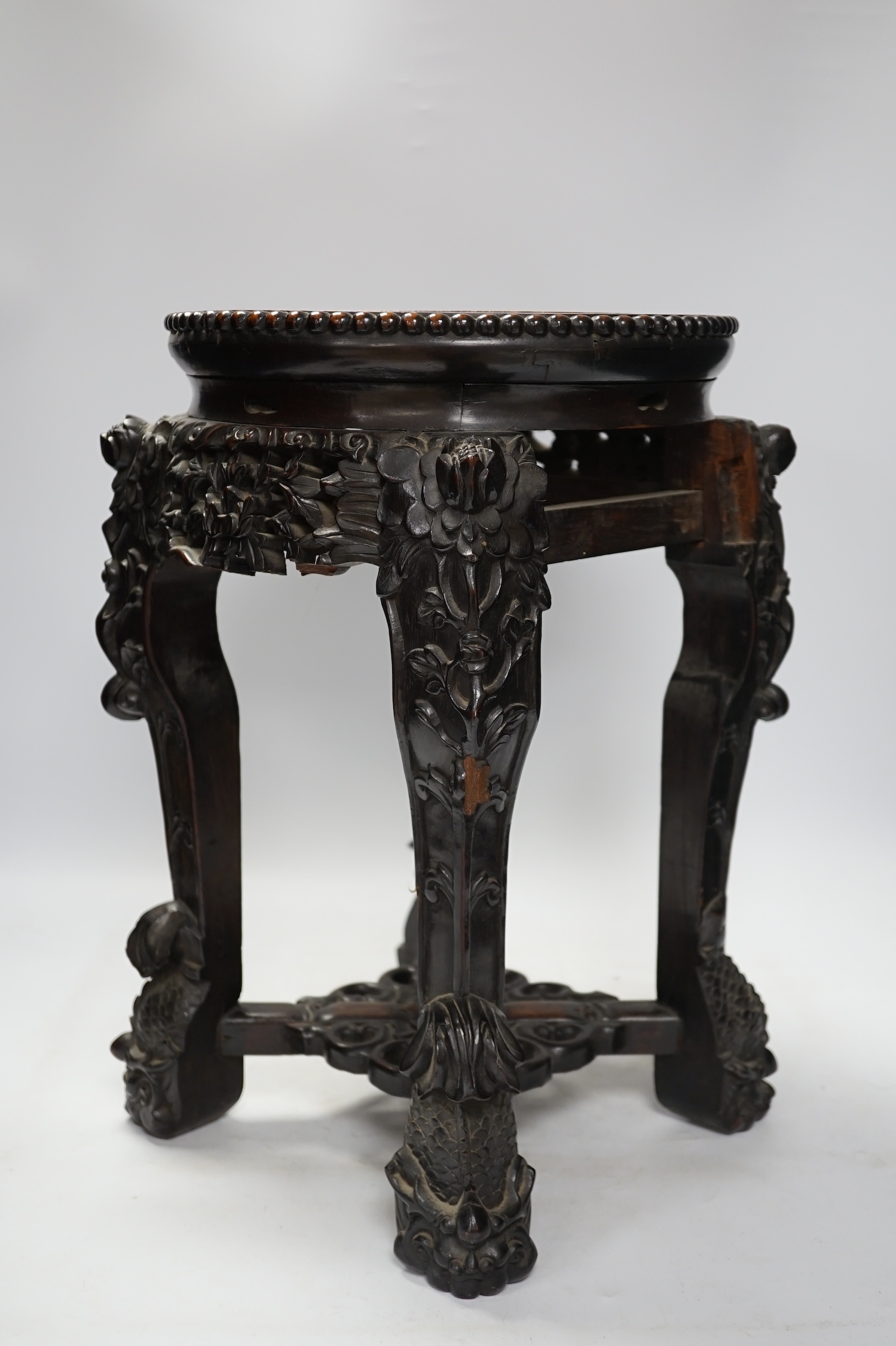 A Chinese hongmu stand, with inset marble top, 42cm high. Condition - poor to fair, section of frieze missing